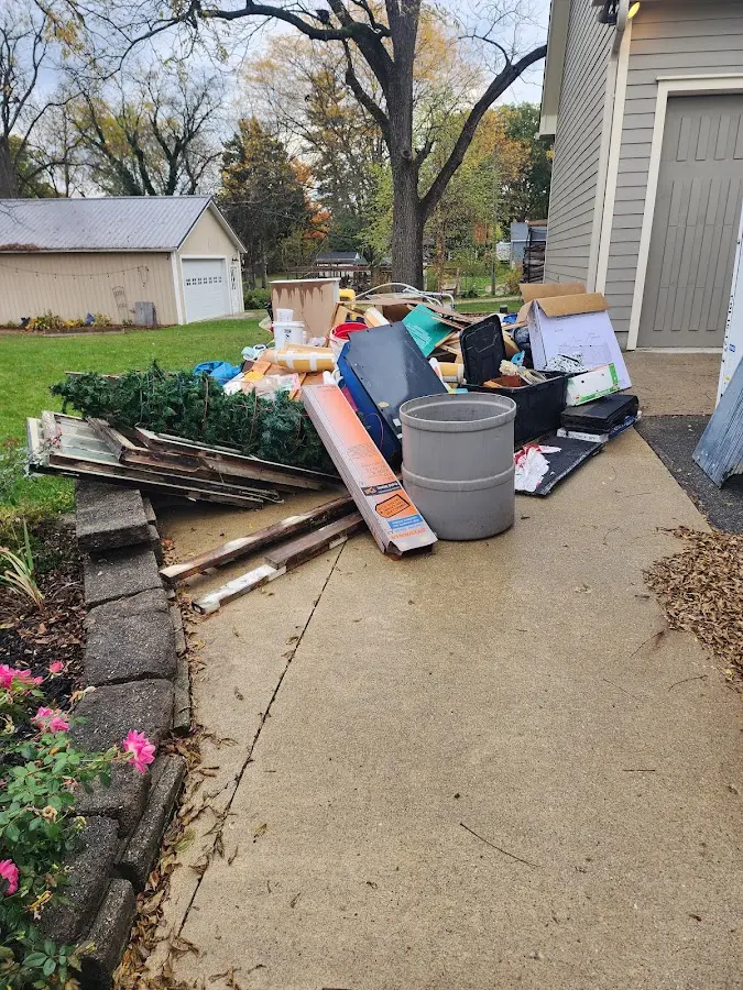 Dumpster being loaded with debris for Demolition Dumpster Rental in Oak Grove